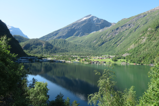 Þorpið Tafjord í júní 2019. Hólarnir aftan við þorpið eru annars vegar fornt framhlaup úr dalnum til hægri á myndinni (hóllinn til hægri) og hins vegar fastur berggrunnur (hóllinn til vinstri).